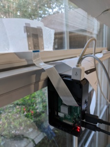 Raspberry Pi setup with a camera facing out a window